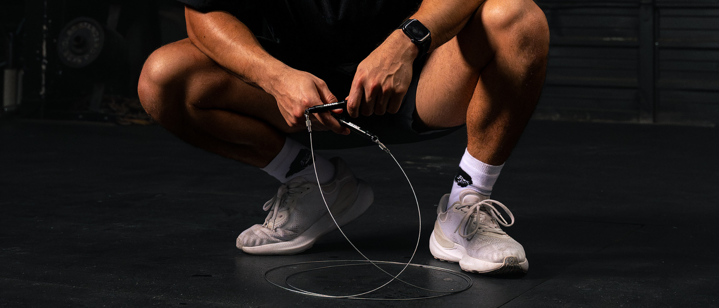 Person holding a jump rope in a dark setting